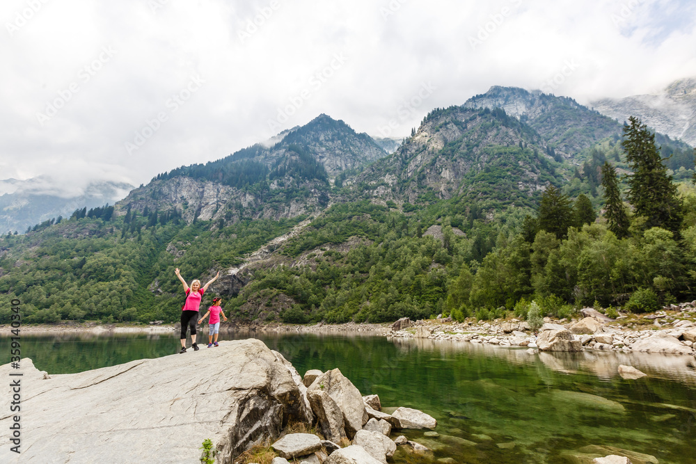 alpine high mountain lake, coniferous woods are reflected in the water, Antrona valley Campliccioli lake, Italy Piedmont alpine high mountain lake, coniferous woods are reflected in the water, Antrona valley Campliccioli lake, Italy Piedmont