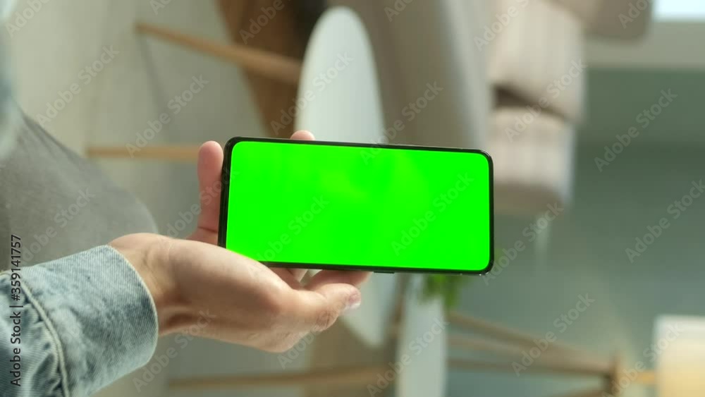 POV View of Man at Phone with Green Screen for Copy Space. Chromakey Mock Up. 20s Boy Watching Video News on Couch Close up. Tap to Click on Centre of Screen With Vertical Screen Orientation 9:16 POV View of Man at Phone with Green Screen for Copy Space. Chromakey Mock Up. 20s Boy Watching Video News on Couch Close up. Tap to Click on Centre of Screen With Vertical Screen Orientation 9:16