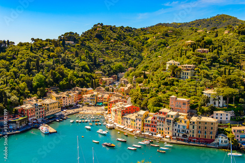 Fototapeta Naklejka Na Ścianę i Meble -  It's Aerial view of Portofino, is an Italian fishing village, Genoa province, Italy. A vacation resort with a picturesque harbour and with celebrity and artistic visitors.