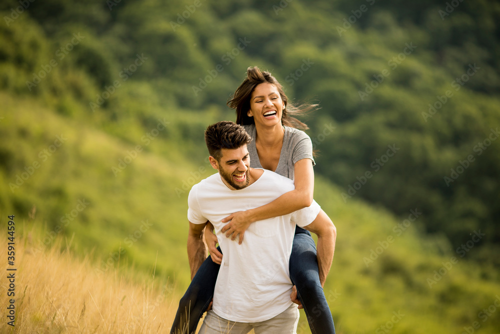 Pretty young couple in love outside in spring nature