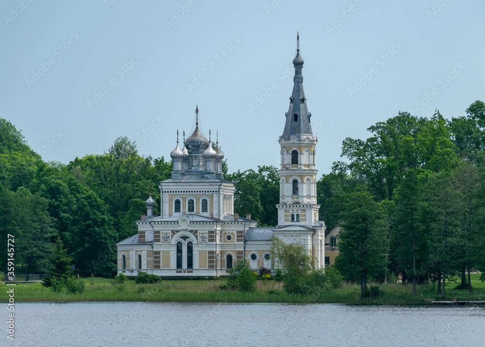 summer landscape with Lake Stameriena and Stameriena Orthodox Church in the background, Latvia