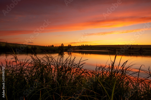 a warm bright sunset over the lake on a summer evening