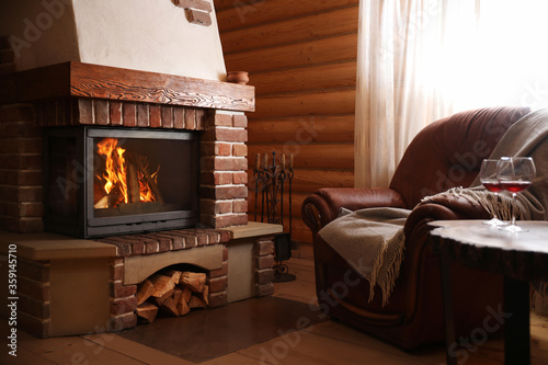 Modern cottage interior with stylish furniture and fireplace. Winter vacation