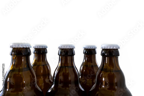 Five sealed beer bottles against a white background