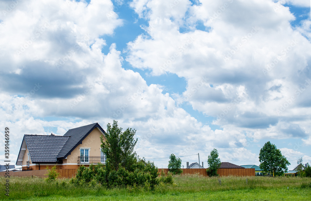 new rural house on a background of cloudy sky new rural house on a background of cloudy sky
