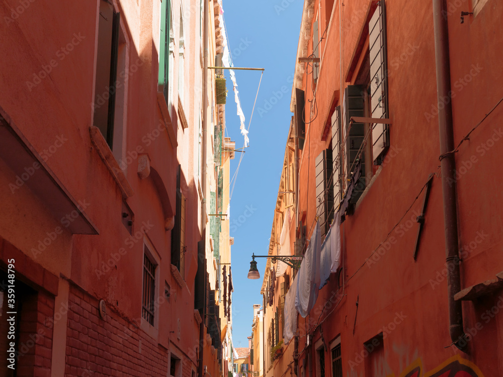 Laundry hanging out to dry in an narrow street, Venice, Italy