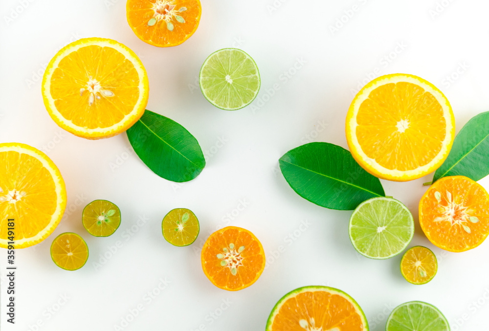 a mix of citrus fruits with leaves in a white background, top view