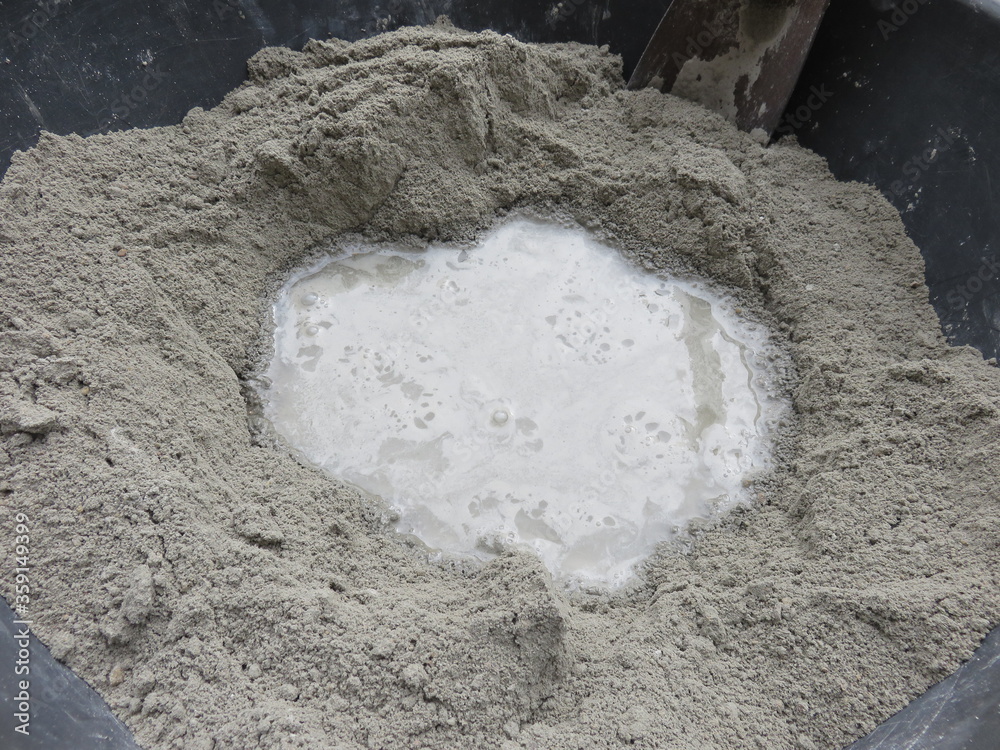 Mixing of sand, water, and Portland cement in powder form which is a