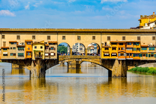 It's Ponte Vecchio (Old Bridge), a Medieval stone closed-spandrel segmental arch bridge over the Arno River, in Florence, Italy.