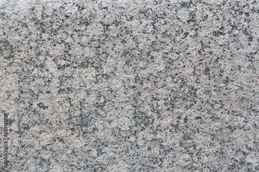 Granite texture. Natural gray granite with a grainy pattern. Stone background. Solid rough surface of rock. Durable construction and decoration material. Close-up. Granite texture. Natural gray granite with a grainy pattern. Stone background. Solid rough surface of rock. Durable construction and decoration material. Close-up.