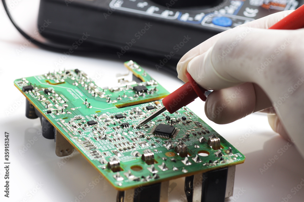 Fototapeta premium Testing SMD component using multitester while servicing / repairing electronic stuff