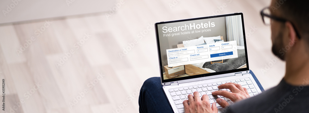 Man Booking Hotel On Website - obrazy, fototapety, plakaty 