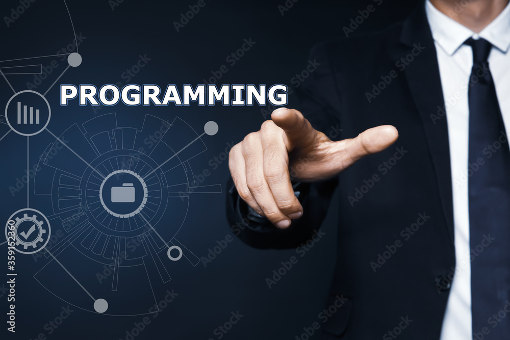 Businessman pointing at word PROGRAMMING on virtual screen, closeup Businessman pointing at word PROGRAMMING on virtual screen, closeup