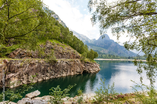 alpine high mountain lake, coniferous woods are reflected in the water, Antrona valley Campliccioli lake, Italy Piedmont photo