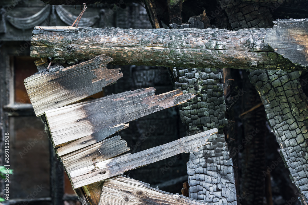 Part of the charred wooden wall of an apartment building after a fire