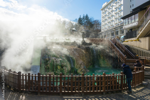 people sightseeing at Yubatake Hotspring with evening light in Gunma ,Japan  photo