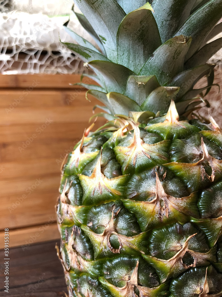 Fototapeta premium pineapple on a wooden table