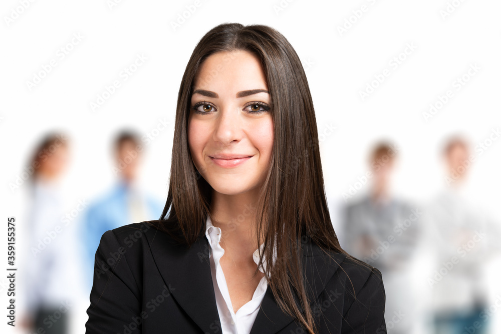 Smiling businesswoman in front of a business team Smiling businesswoman in front of a business team