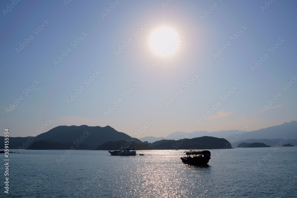 Sun , sea, island and boat. Sai Kung, Hong Kong. Sun , sea, island and boat. Sai Kung, Hong Kong.