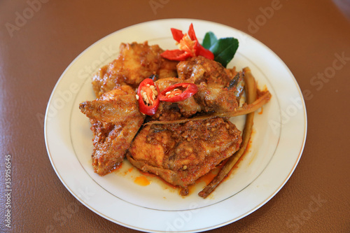 Photos of chicken food cooked spicy and served on a plate