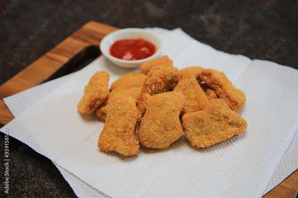 Serve chicken nuggets with vegetables and saur on a white plate Serve chicken nuggets with vegetables and saur on a white plate