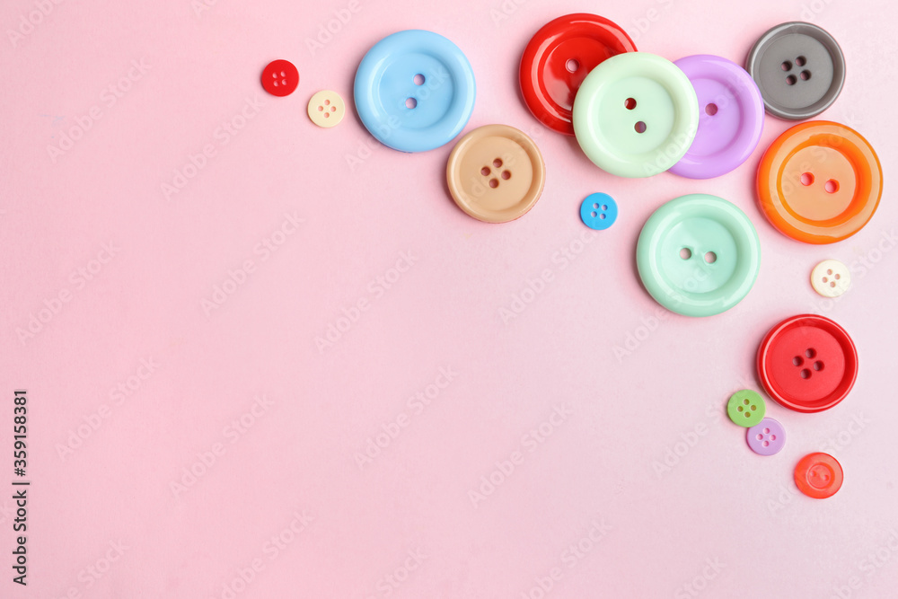 Many sewing buttons on pink background, flat lay. Space for text Many sewing buttons on pink background, flat lay. Space for text
