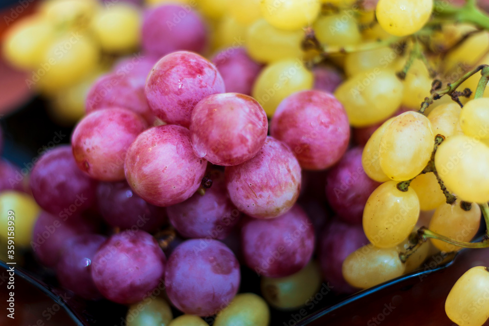 Red and White wine bunch of grapes in the black plate Red and White wine bunch of grapes in the black plate