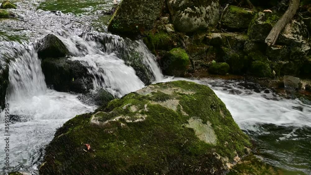 Wonderful fresh water rapids and waterfalls river flowing through forest in early sprting Wonderful fresh water rapids and waterfalls river flowing through forest in early sprting