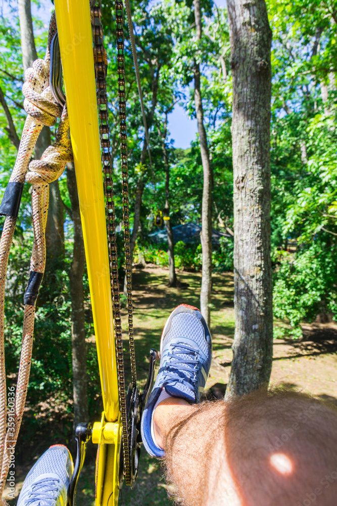 Fototapeta premium Hanging bike in the air. Canopy tour in Pointe Noire, Basse-Terre, Guadeloupe