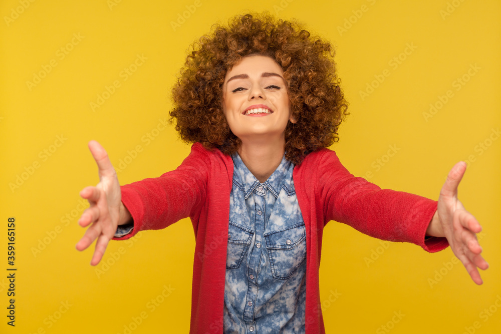 Who wants free hugs? Portrait of friendly curly-haired woman welcoming with wide raised hands and ready to embrace, sharing love, sincere meeting guests with smile. indoor studio shot, isolated Who wants free hugs? Portrait of friendly curly-haired woman welcoming with wide raised hands and ready to embrace, sharing love, sincere meeting guests with smile. indoor studio shot, isolated