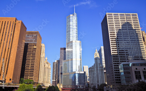 Chicago River with bridges and boats, street and Chicago skyline with modern architecture skyscrapers and highrises like the Trump Tower photo