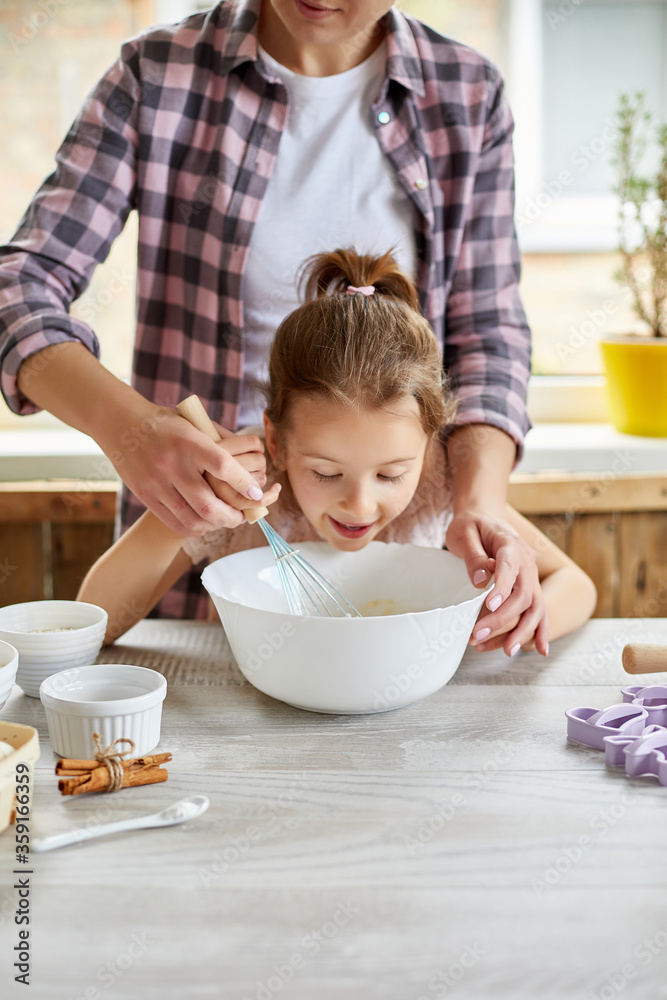 Mother teaching daughter prepare dough together in kitchen Mother teaching daughter prepare dough together in kitchen