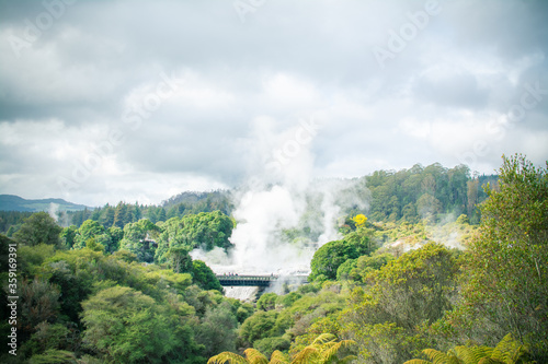 Clouds of steam rising over geothermal zone in the mountains