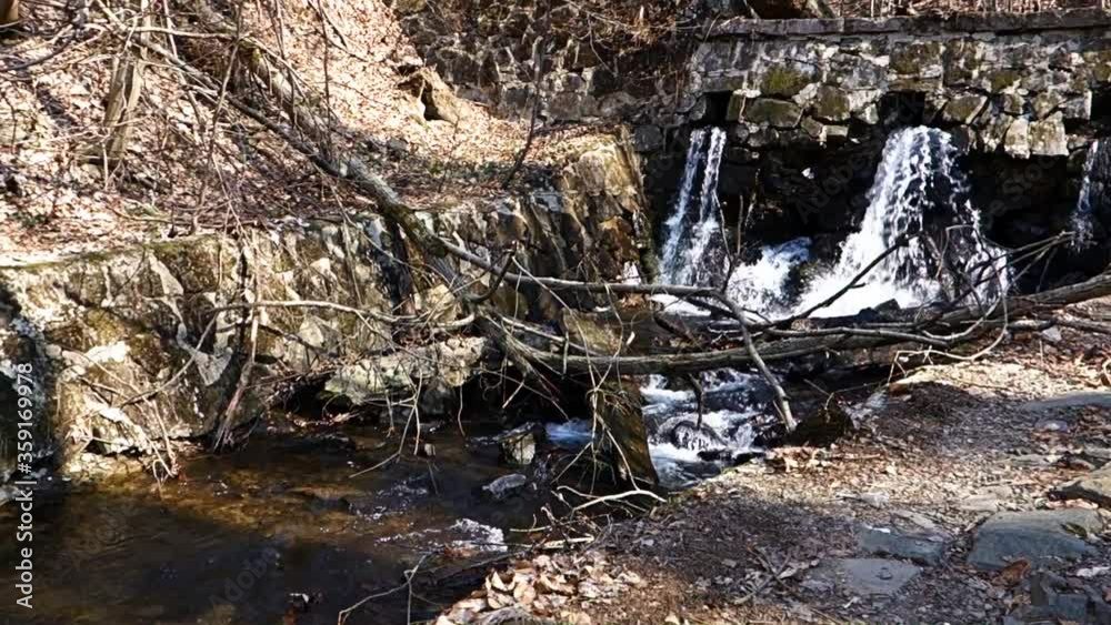 Mountain water flows from a stone dam Mountain water flows from a stone dam