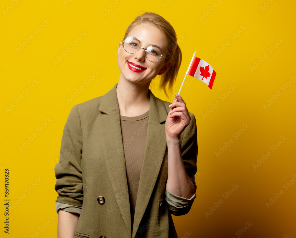 Φωτογραφία Style blonde woman in jacket with Canadian flag on yellow background