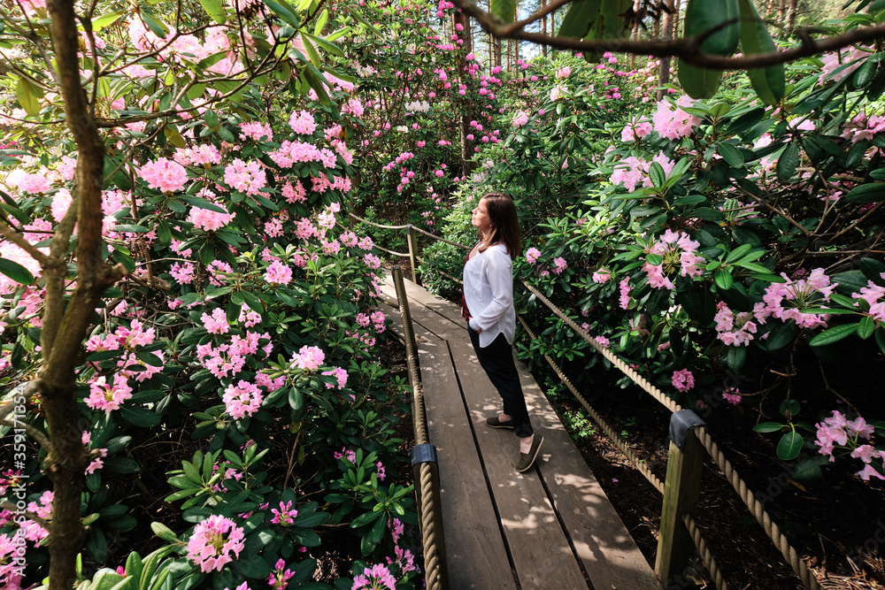 Woman walking in Rhododendrons Park. It is one of the most popular and beautiful places in Helsinki, Finland.