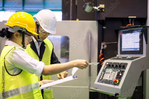 Factory auditor and inspectot at machine photo