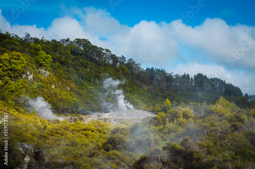 Clouds of hot steam rising from geothermal zone in mountains near Rotorua