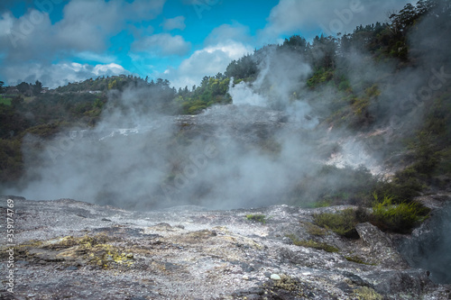 Smoking ground s- steam rising over geothermal area in mountains near Rotorua