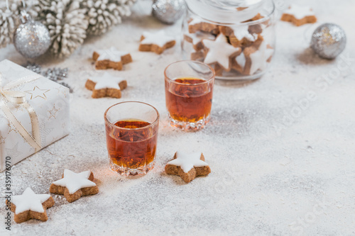 Whiskey, brandy or liquor, cookies and chrastmas decorations on white background