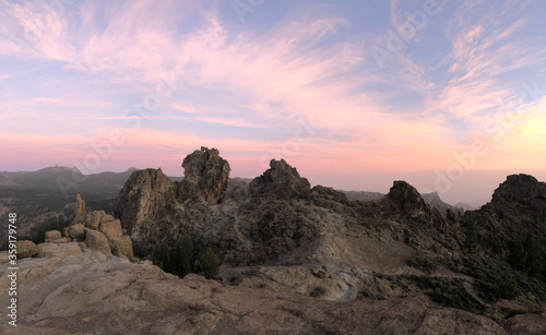 Sunset and pink sky at Roque Nublo the volcanic rock