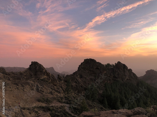 Sunset and pink sky at Roque Nublo the volcanic rock © TravelTelly