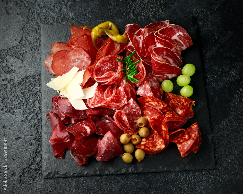 Set of Salami, chorizo, coppa, lomo, beef, Meat antipasto platter on stone board