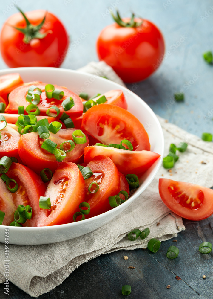 Tomato salad with spring onion and herbs in white bowl. Healthy summer food Tomato salad with spring onion and herbs in white bowl. Healthy summer food