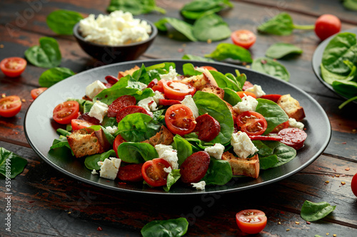 Chorizo Tomato salad with spinach, feta cheese and croutons. healthy summer food © grinchh