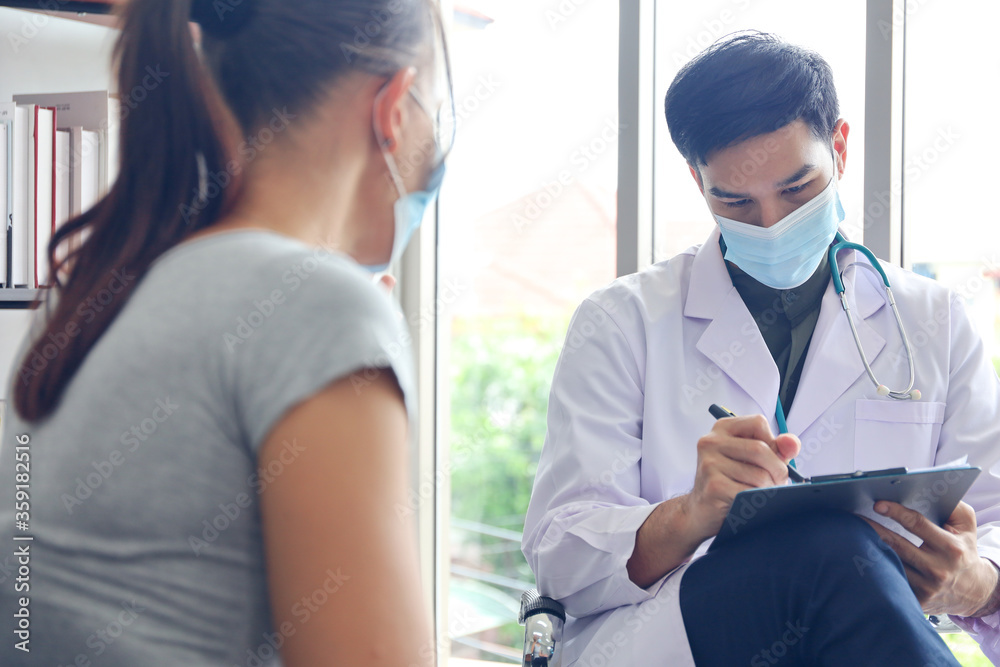 Patient woman wear face mask and talking with a doctor, problem healthy interview or consulting or diagnostic treatment, social distancing and virus protection Patient woman wear face mask and talking with a doctor, problem healthy interview or consulting or diagnostic treatment, social distancing and virus protection