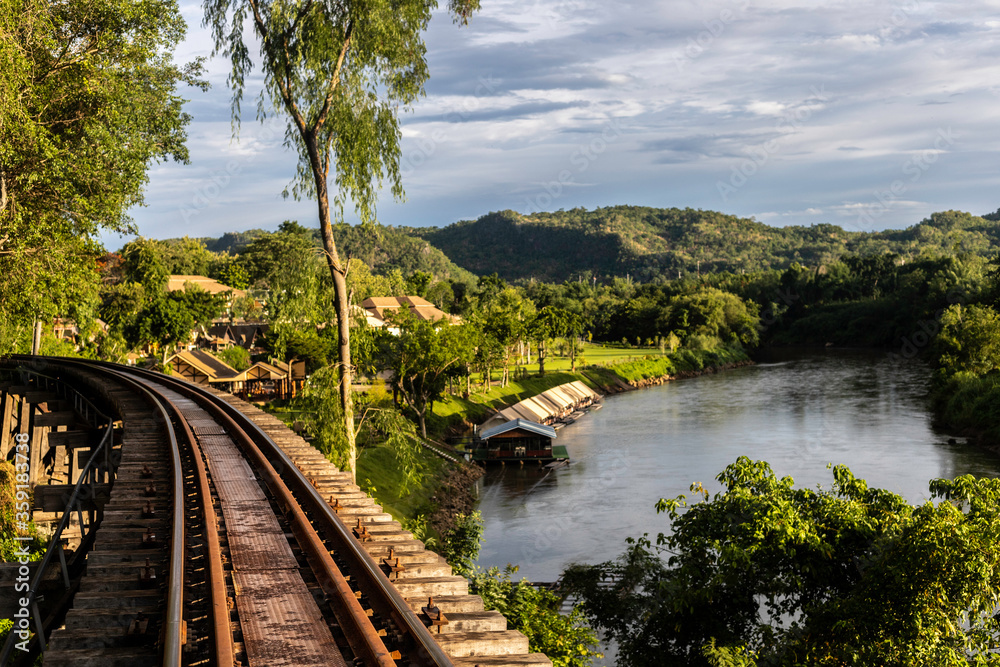 Railway bridge on a cliff along the river under blue sky on sunny day. Railway bridge on a cliff along the river under blue sky on sunny day.
