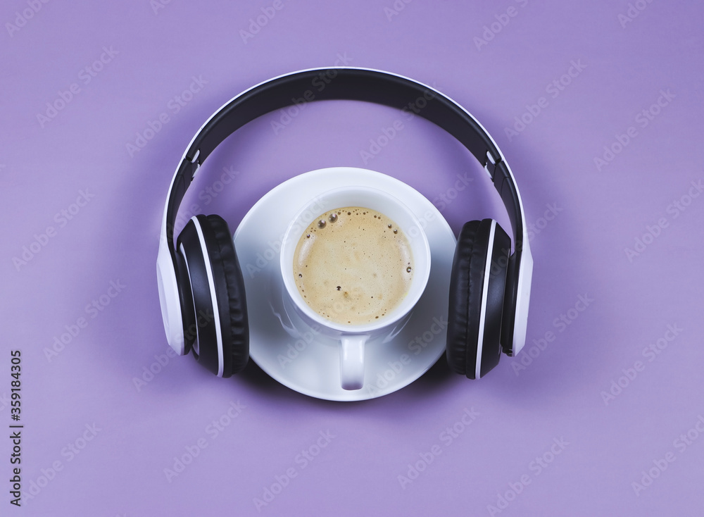flat lay of headphones and coffee cup on purple background.Music and coffee relaxing time concept. flat lay of headphones and coffee cup on purple background.Music and coffee relaxing time concept.
