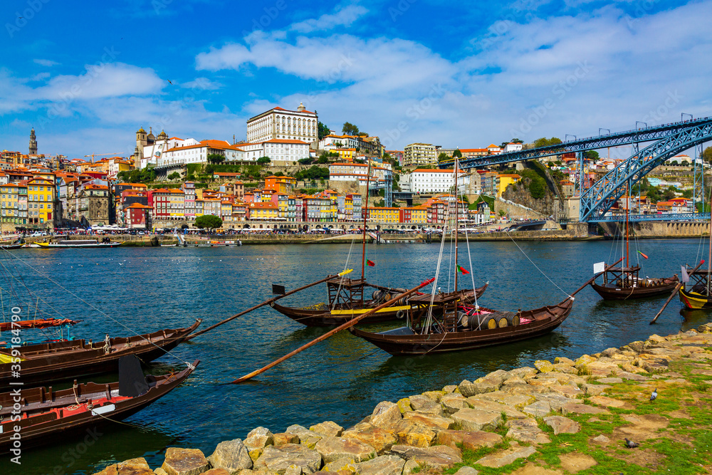 Porto, Portugal Riberia old town cityscape with Dom Lusi bridge and the Douro River with traditional Rabelo boats