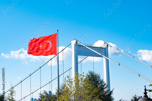 Fatih Sultan Mehmet Bridge Istanbul Turkey. views of the Bosphorus istanbul. Fatih Sultan Mehmet Bridge and Turkish Flag. Turkish flag in the light blue sky. photo